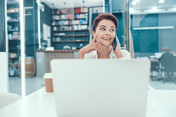 Fototapeta premium Dreamy mood of smiling office worker stock photo