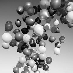 lots of balloons flying in the sky. monochrome, black and white