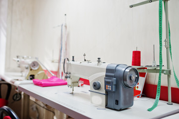 Workplace of seamstress office with sewing machine on table.