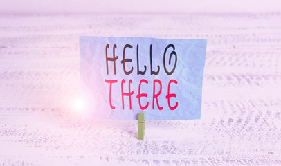 Word writing text Hello There. Business photo showcasing a way to get someone s is attention more strongly upon greeting Green clothespin white wood background colored paper reminder office supply
