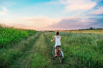 woman riding bike in the field