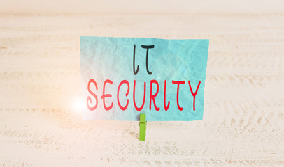 Word writing text It Security. Business photo showcasing protection of data or digital asset against unauthorized access Green clothespin white wood background colored paper reminder office supply