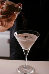 Close up of bartender making martini. Cocktail based on milk and coffee.