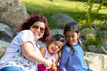 Cute family of mother and daughters in the garden