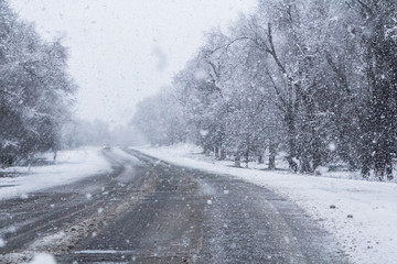 Fototapeta premium Turn on a snowy road with poor visibility