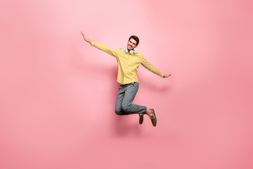 Full length photo of handsome guy jumping high enjoy summer time using earflaps flying like bird...