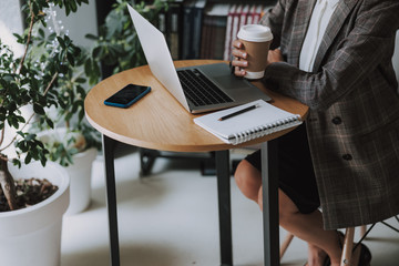 Coffee to go in hand of elegant lady stock photo