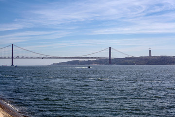 The 25 de Abril Bridge is a suspension road-rail bridge over the Tagus River that connects the city of Lisbon, capital of Portugal, to the municipality of Almada, on the left bank of the river.