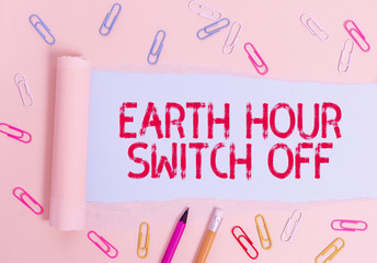 Writing note showing Earth Hour Switch Off. Business concept for The Lights Out Event Annual Movement Planet Day Stationary and torn cardboard placed above plain pastel table backdrop