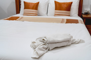 Fototapeta na wymiar White towel on a wooden bed