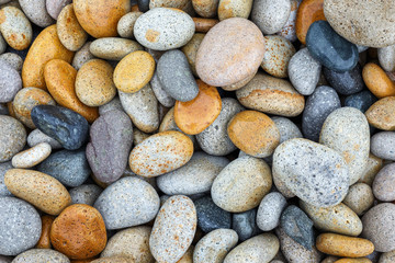 Fototapeta na wymiar Smooth pebbles at beach, closeup top view. Abstract natural texture background