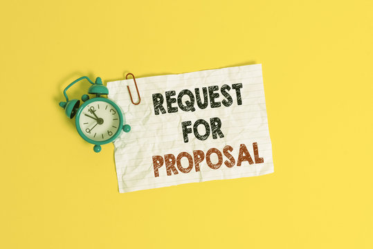 Text sign showing Request For Proposal. Business photo showcasing document contains bidding process by agency or company Metal alarm clock clip blank crushed note sheet colored background