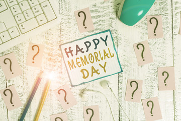 Writing note showing Happy Memorial Day. Business concept for Honoring Remembering those who died in military service Writing tools and scribbled paper on top of the wooden table