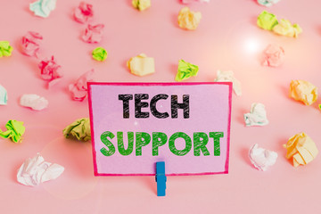 Writing note showing Tech Support. Business concept for advising and troubleshooting service provided by a analysisufacturer Colored crumpled papers empty reminder pink floor background clothespin