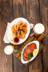 Beer with appetizers red fish and shrimp