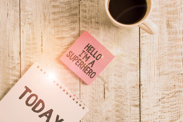 Word writing text Hello I M A Superhero. Business photo showcasing Believing in yourself Selfconfidence Introduction Stationary placed next to a cup of black coffee above the wooden table