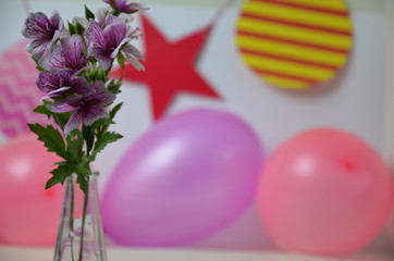 Children's birthday. Table decorations, balloons, treats, juice and gifts. A lot of colorful balloons prepared for a child`s birthday party that will surely end up exploding. Synonym of fun and joy.