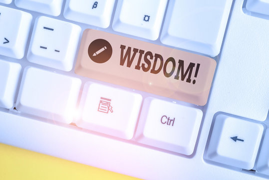 Text sign showing Wisdom. Business photo showcasing the ability to use your knowledge and experience to make decisions White pc keyboard with empty note paper above white background key copy space