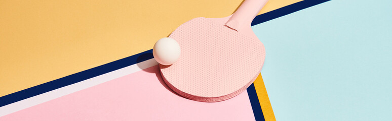 Pink ping pong racket and ball on abstract background with blue lines, panoramic shot
