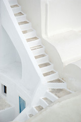 Simple staircase twisting through traditional Mediterranean whitewashed architecture on the Greek island of Santorini 
