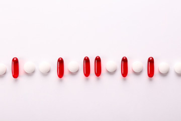 Flat lay composition with bunch of different colorful pills on the table. Pile of opened medication...
