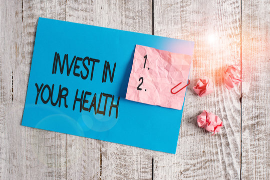 Word writing text Invest In Your Health. Business photo showcasing Live a Healthy Lifestyle Quality Food for Wellness Wrinkle paper and cardboard plus stationary placed above wooden background