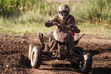 Motocross quad race with races who are covered with mud in an old motocross track. 