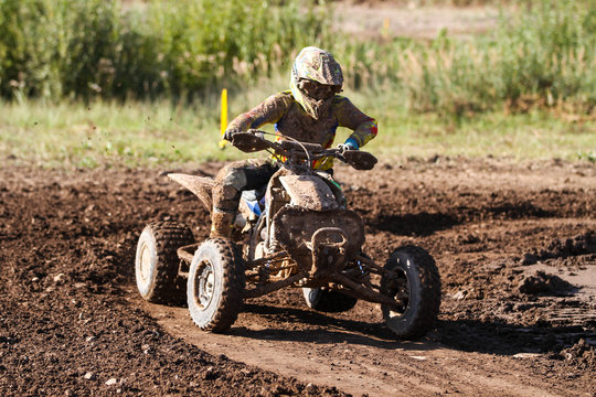 Motocross quad race with races who are covered with mud in an old motocross track. 