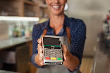 Waitress showing credit card machine