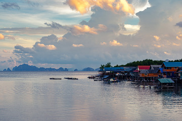 Small village in sea with sunset sky and limestone islands