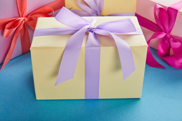 colorful gift boxes with ribbons and bows on blue background