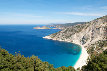 Bright scenic landscape view of Mediterranean Sea lapping at the white stone shore at Myrtos Beach, Kefalonia, Greece