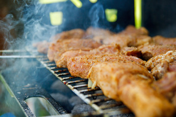 A thick strip steak being grilled outdoors