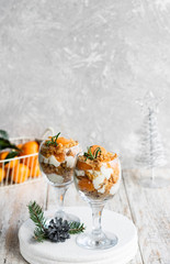 Citrus trifle with fresh tangerines. Christmas portioned dessert on the festive table.