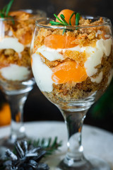 Citrus trifle with fresh tangerines. Christmas portioned dessert on the festive table.