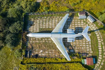 Aerial drone top view photo of abandoned passenger air plane in old airport no longer used