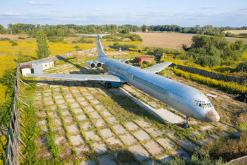 Aerial drone top view photo of abandoned passenger air plane in old airport no longer used
