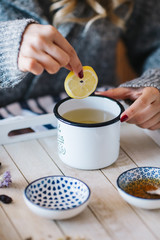 a warm tea to heat a cold winter. The girl is holding herbal tea. a cup of linden tea