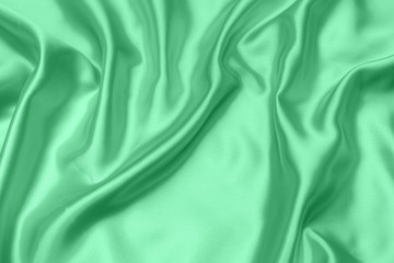 green satin fabric texture soft blur background