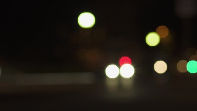 Defocused Night City Lights near Eiffel Tower in Paris. Color Blurred bokeh of moving cars and bus in street. Static Shot 4K UHD.