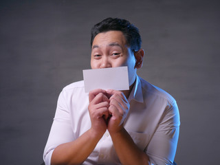 Happy Smiling Businessman Covering His Face With Blank Paper Card