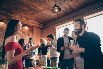 Portrait of nice attractive charming lovely cheerful cheery guys gathering enjoying festal day tradition together talking communicating at modern industrial brick wood loft style interior house