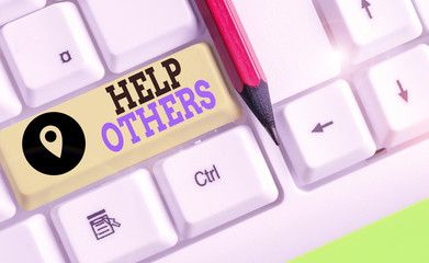 Writing note showing Help Others. Business concept for the action of helping someone to do...