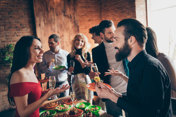 Profile side view portrait of nice attractive cheerful colleagues celebrating birthday enjoying tradition together talking at modern industrial brick wood loft style interior house