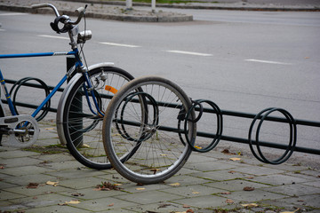 A stolen bicycle with a wheel left locked to a rack