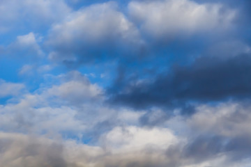 Naklejka na ściany i meble Beautiful white clouds on a background of blue sky. Defocused image for design.