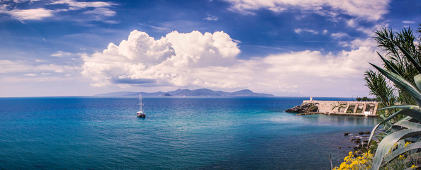 Cloudy Piombino (Tuscany) shore panorama with the island Elba in the distance