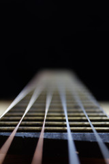 acoustic guitar strings on black background