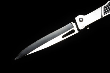 Foldable chrome knife blade on black background