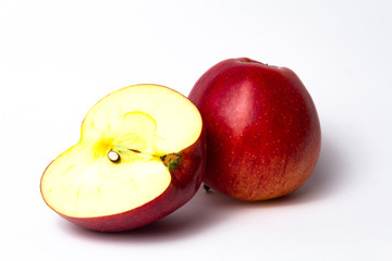 red apple cut in half on a white background